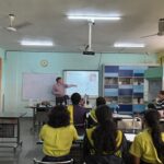 Classroom view of Dr. Andrew Flaus leading a hands-on learning experience for students.